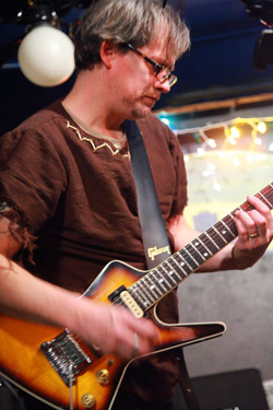 Locksley Wolfstache playing his guitar